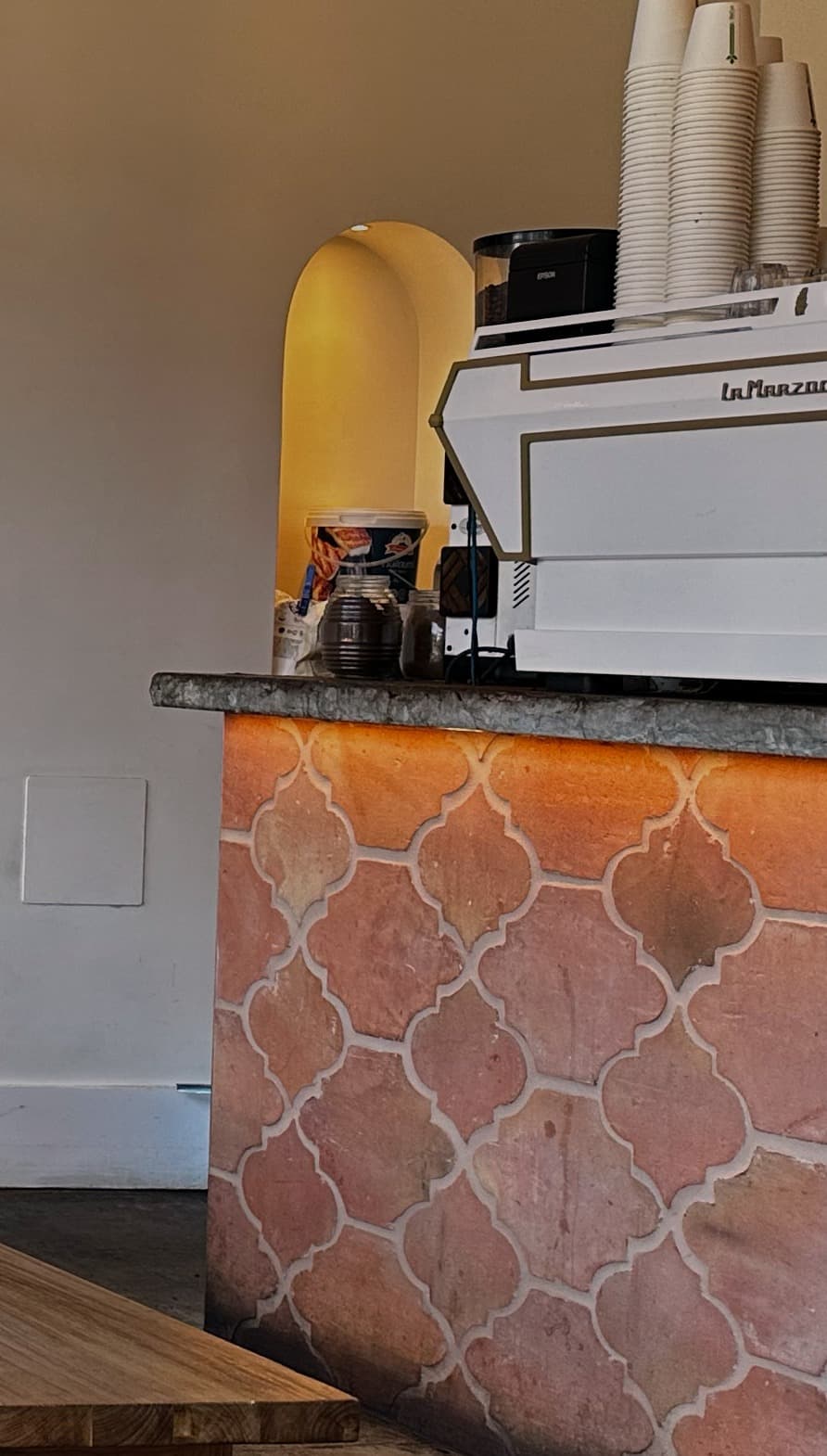 The terracotta-tiled counter and espresso machine